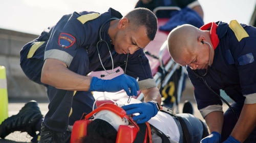 Emergency service technicians helping patient.