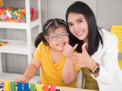 Smiling teacher with student.