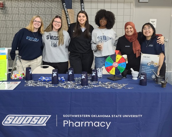Pharmacy students at recruiting table.